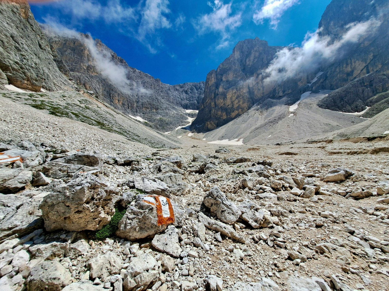 A rocky area with rocks and a sign in the foreground